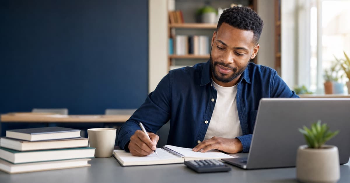 Adult learner studying for the GED math test with algebra notes and calculator
